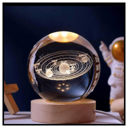 🔮 3D Crystal Ball Night Light – Glowing Glass Sphere with Laser Engraved Solar System on Round Wooden Base with Warm Light and Small Astronaut Figure in Background