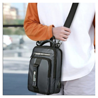 Black waterproof chest sling bag for men with shoulder strap worn as crossbody messenger bag