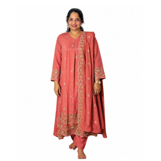 A woman modeling a traditional Indian salwar kameez set in a dusty coral pink color with gold floral embroidery, standing against a plain white background - Mayuri Terracotta Churidar - S.NO 406118