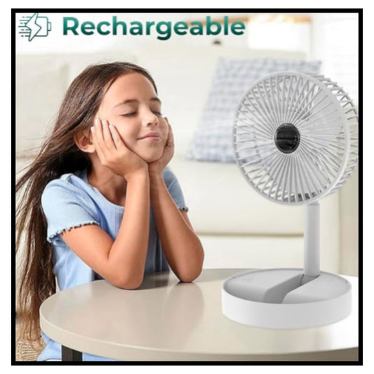 Young girl with long brown hair resting head on hands at table with white rechargeable desk fan